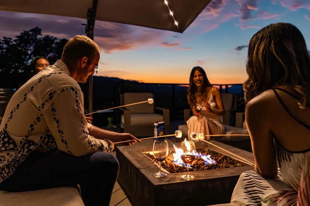 Family Making Smores Around Firepit